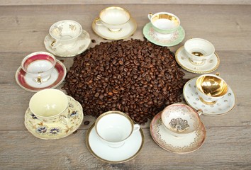 Many small multi-colored porcelain cups stand on the table in the form of a circle