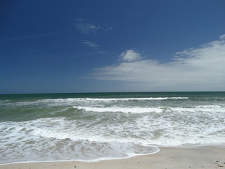 sunny sky and surf at the beach 