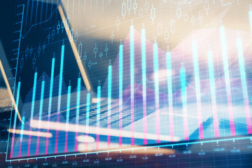 Financial chart drawing and table with computer on background. Double exposure. Concept of international markets.
