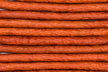 Kabanos or Cabanossi Thin Dry Smoked Polish Sausage Background. Selective focus.