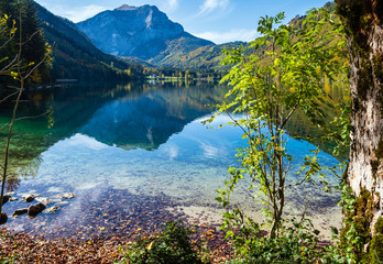 Peaceful autumn Alps mountain lake with clear transparent water and reflections. Langbathseen lake, Upper Austria.