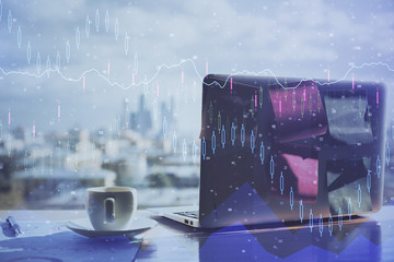 Financial graph colorful drawing and table with computer on background. Double exposure. Concept of international markets.