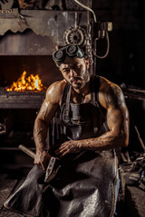 portrait of strong muscular blacksmith man wearing black apron, look confidently, have strong...