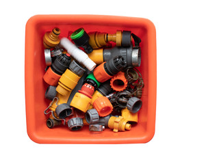 A box of well used garden hose attachments