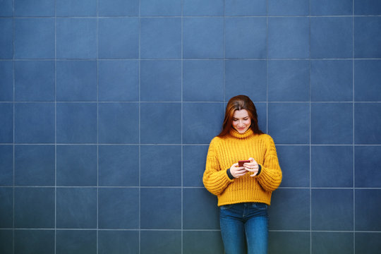 Young Redhead Woman Sending Text Message With Phone Outdoor