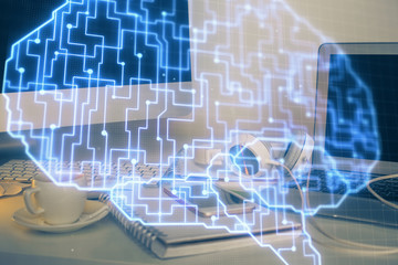 Double exposure of table with computer and brain hologram. Data innovation concept.
