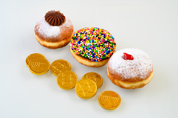 Fresh donuts and gold coins  for Hanukkah celebration.