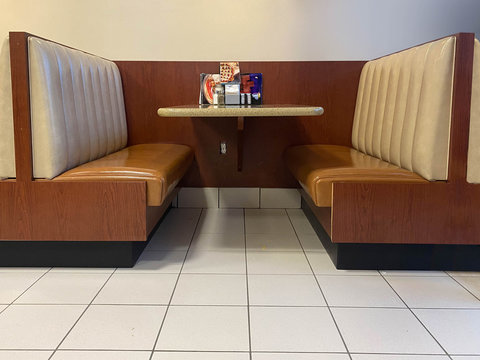 Diner seating with booth, floor, table and generic menu cards