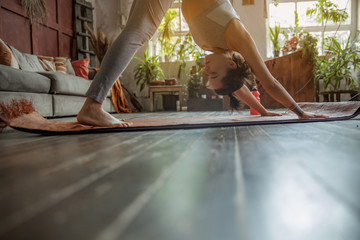 Pretty woman is wearing sportswear at home