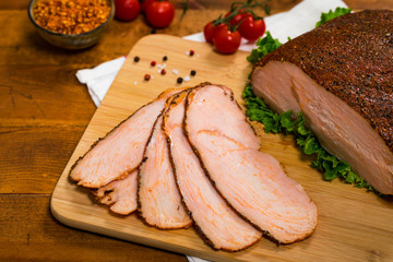 Roasted Turkey Breast Cajun Style Deli Lunch Meat on Old Wooden Background. Selective focus.