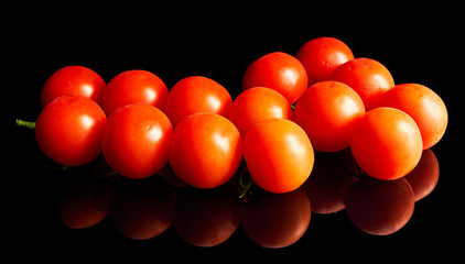 red cherry tomatoes on a black background