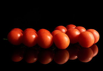 red cherry tomatoes on a black background