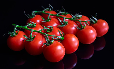 red cherry tomatoes on a black background