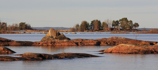 Naklejka premium Rock formations and small island at the shore of Lake Vanern, Sweden.