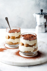 Traditional Italian dessert tiramisu in a glass.