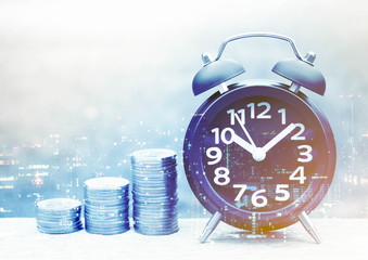 bottle of coins and alarm clock, business concept