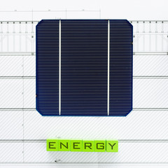 Solar energy in a conceptual image with solar or photovoltaic cells on house blueprints, top view.