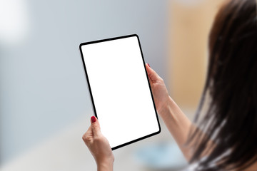 Woman holding tablet in vertical position with isolated screen for app or web site presentation....