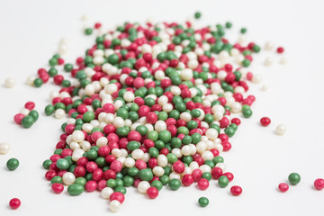 heap of colorful sugar sprinkles in red, green and white
