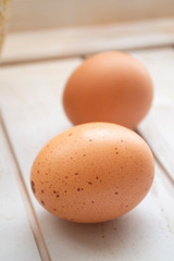 Close up of chicken eggs, fresh farm brown eggs over a rustic wooden table. Vertical image