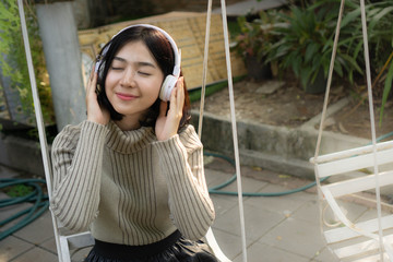 portrait of asian young woman listening music
