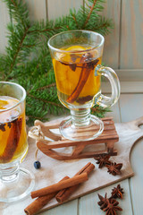 Hot mulled wine with Christmas spices and orange slices, anise and cinnamon sticks, vertical bright image