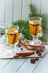 Mulled wine in bubs and Christmas decoration. Christmas spices and orange slices, anise and cinnamon sticks