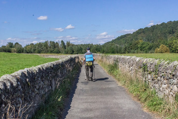 Roman wall along the way. Ancient masonry. Path pilgrim Camino de Santiago. Hiking in Europe. Walking route. Route through the plains and fields. Traveling with a backpack.