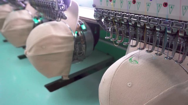 Footage of Embroidery machine needle on embroidery cap in Textile Industry at Garment Manufacturers (selective focus and soft focus)