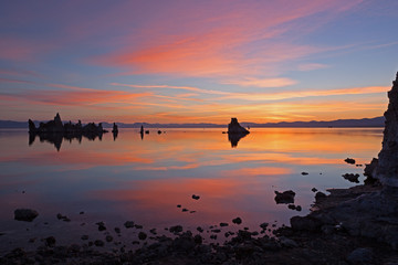 Dawn, Mono Lake with tufa formations and reflections in calm water, California