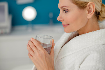 Close up of attractive lady with glass of water