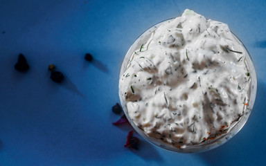 Greek Tzatziki sauce in a sauce-boat on table