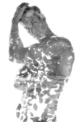 Double exposure, of a young shirtless muscular man combined with leaves of a tree, black and white