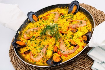 Pot with yellow rice and sea food