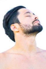 Obraz premium Close up profile portrait of healthy man with black hair and beard, tilting his head back