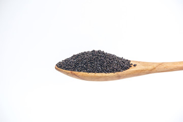 Grain seeds in the wooden spoon isolated on a white background.