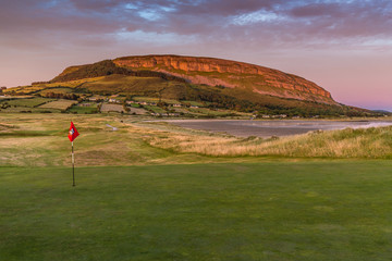 Strandhill golf green and flag with Knocknarea hill in the background