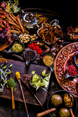 Top view Thai spices and herbs ingredient decoration on wood table for cook in home kitchen. 