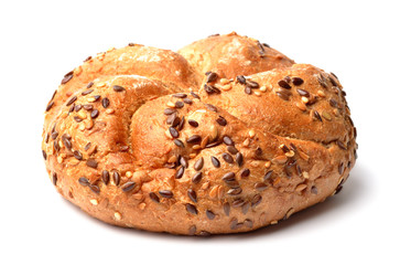 Wholemeal fitness bun with seeds and grains isolated on white background.