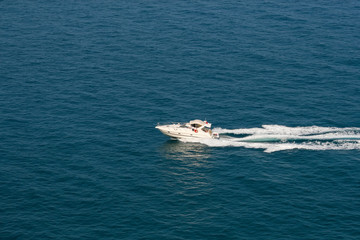 Naklejka premium The speedboat traveling fast in the Mediterranean Sea and the trail it left behind