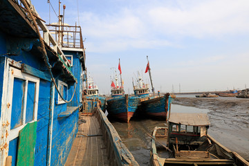 Fototapeta na wymiar wooden fishing vessel in fishing port wharf, China