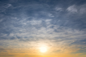 Naklejka na ściany i meble evening sun and blue cloudy sky, dramatic sunset background