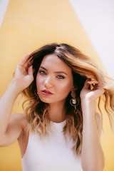 Fototapeta premium Portrait of beautiful young woman with makeup in fashion white clothes