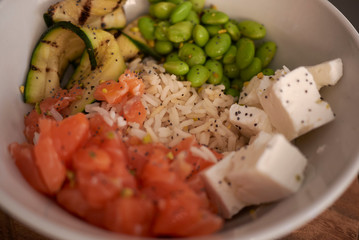 Poke with salmon, edamame, courgette, feta and rice