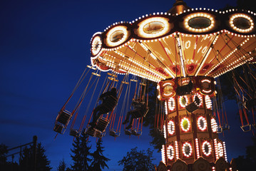 Carousel Merry-go-round in amusement park at a night city