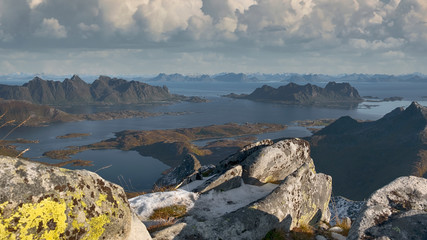 Panorama view from the mountain Rundfjellet to the surrounding snow capped peaks and the sea on the Lofoten Islands, Norway