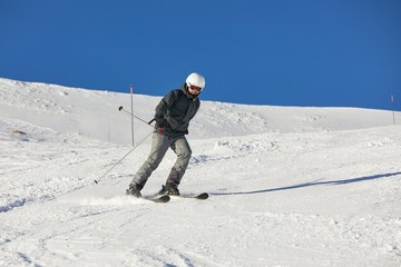 Fototapeta na wymiar Skiers sliding down a snowy slope