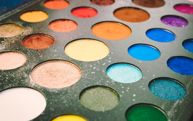 Closeup of multi-colored cosmetic powder for professional makeup artist