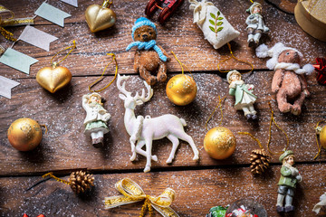Christmas composition. Festive balls, Christmas decor, deer, bears on a wooden background.
