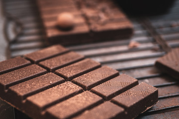 Dark chocolate bars on a black grill